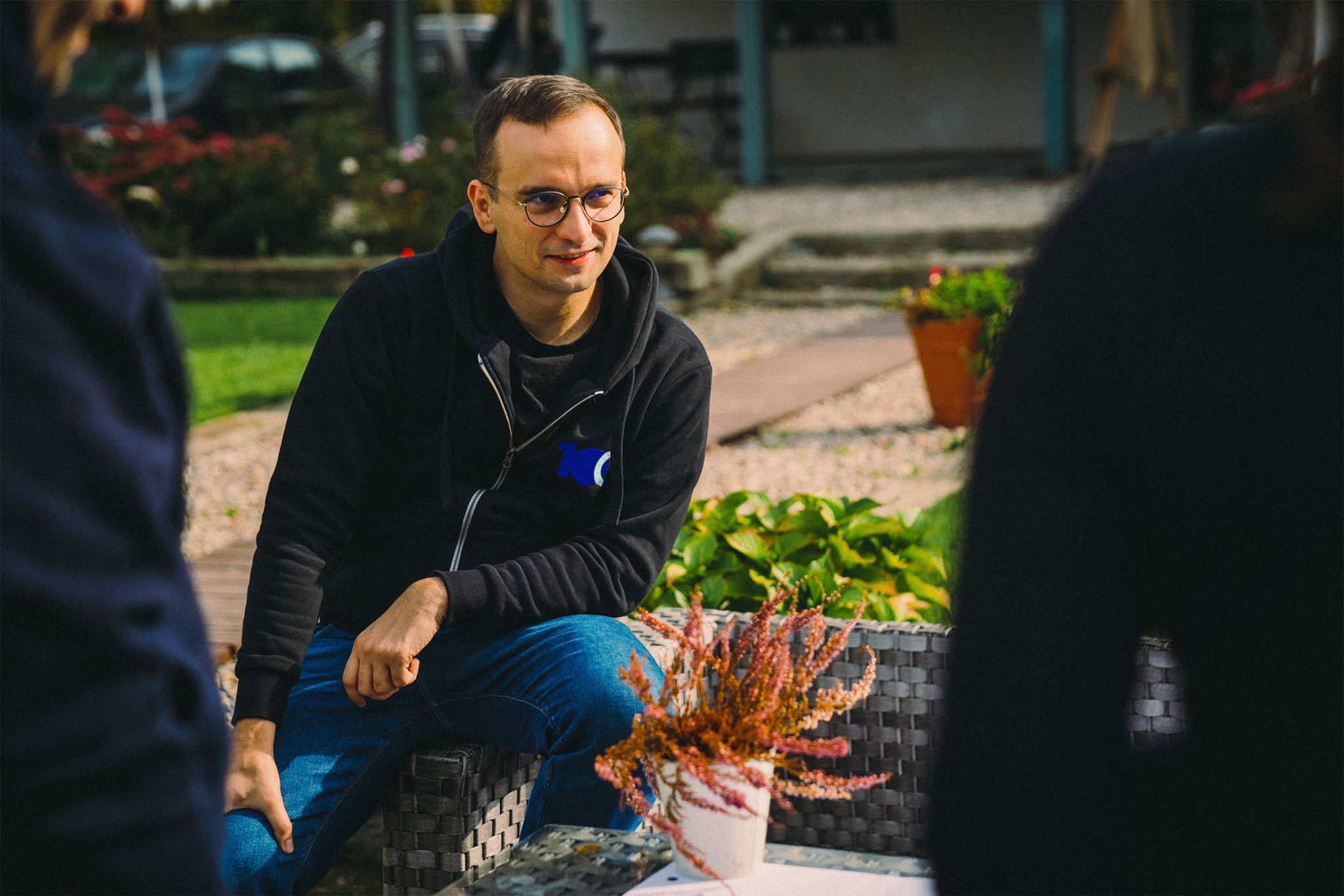 Maciej listening in conversation outdoors